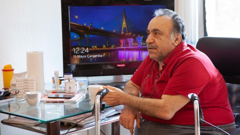 Elderly man at his desk.